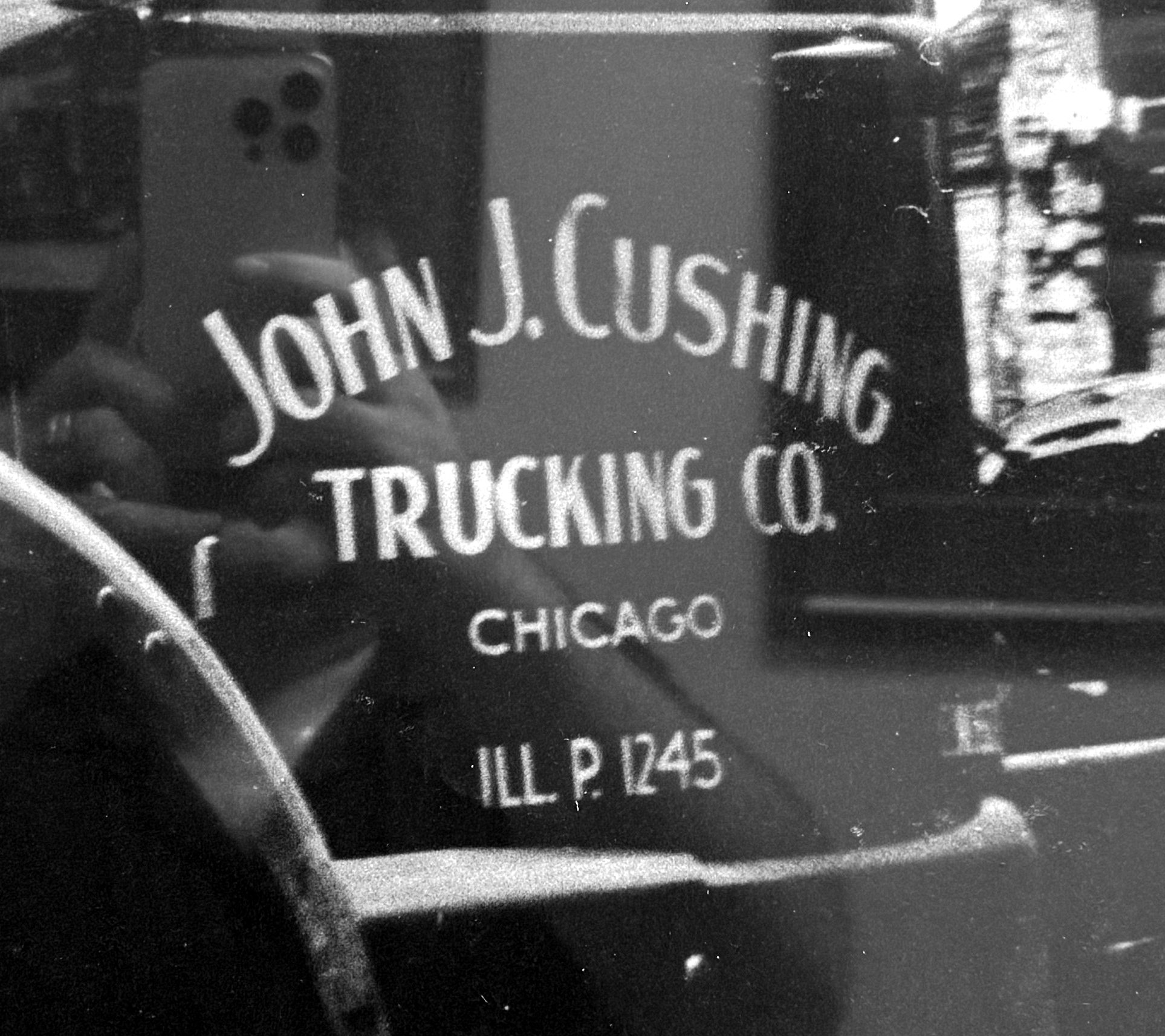 The door of a 1940s White truck hand-lettered JOHN J. CUSHING TRUCKING CO., CHICAGO, ILL. P. 1245